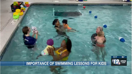 Parents and toddlers playing in the pool on channel 12 news