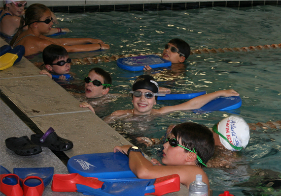 Swimming instructors teaching a swim class.